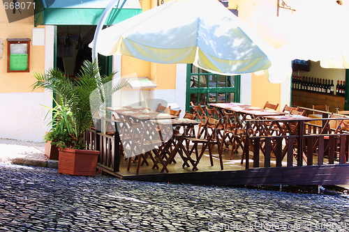 Image of empty tables in street cafe