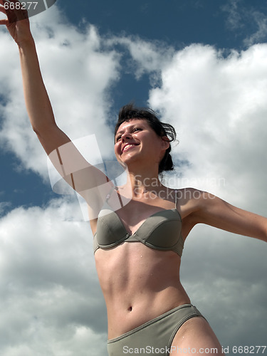 Image of Girl in bikini throwin ball