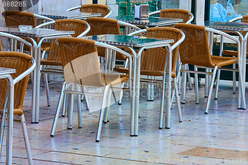 Image of empty tables in street cafe