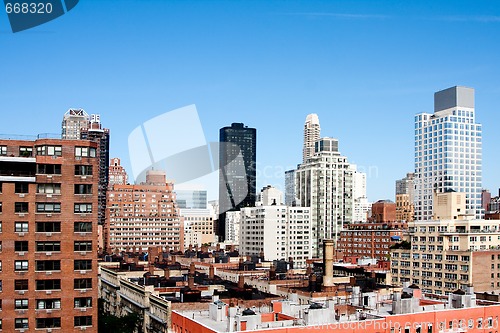 Image of Building rooftops under blue sky