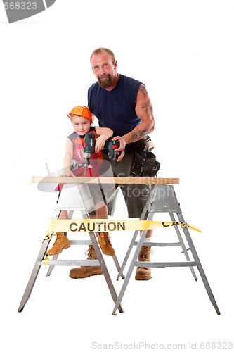 Image of Father teaching son drilling