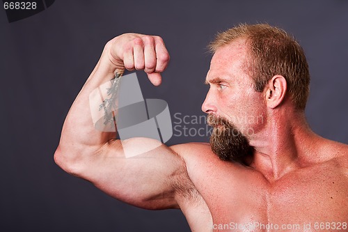 Image of Man showing biceps