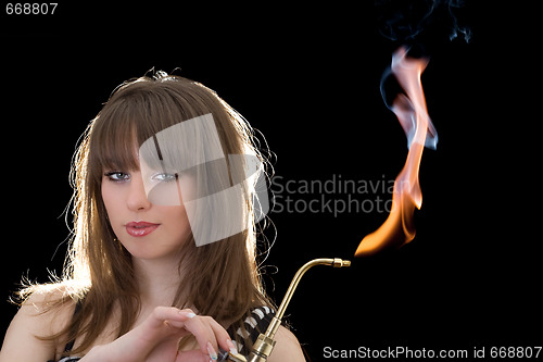 Image of Portrait of the young woman with a gas torch