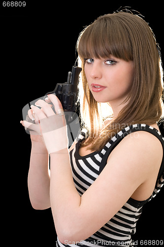 Image of Attractive young woman with pistol. Isolated on black