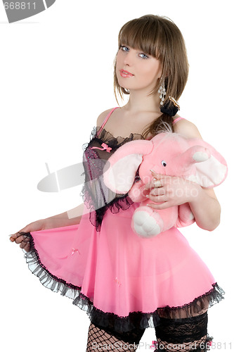 Image of Playful girl in a pink dress with the elephant calf