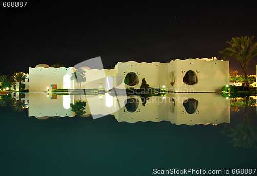 Image of Oriental style buildings night reflection in pool