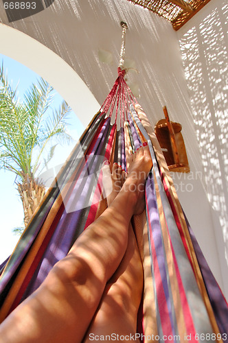 Image of woman legs in hammock - portrait