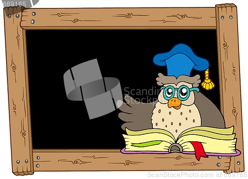 Image of Wooden blackboard with owl teacher