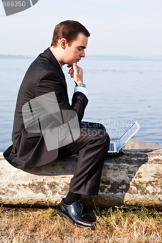 Image of Caucasian businessman with laptop