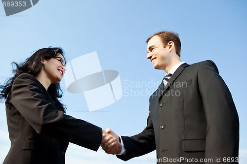 Image of Business people shake hands