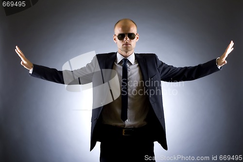 Image of Successful businessman with arms open