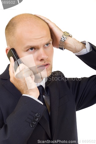 Image of Businessman with bad news on his cell phone