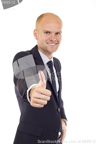 Image of young business man going thumb up