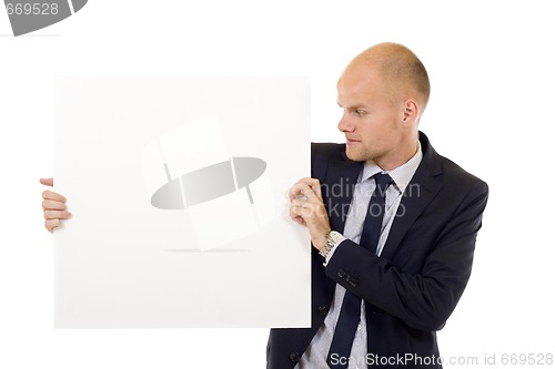 Image of Businessman holding blank board