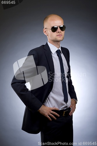 Image of businessman with hands on hips