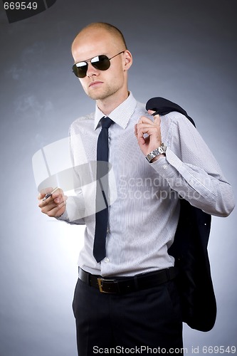 Image of young businessman smoking 