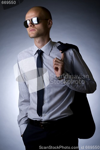 Image of young businessman looking away