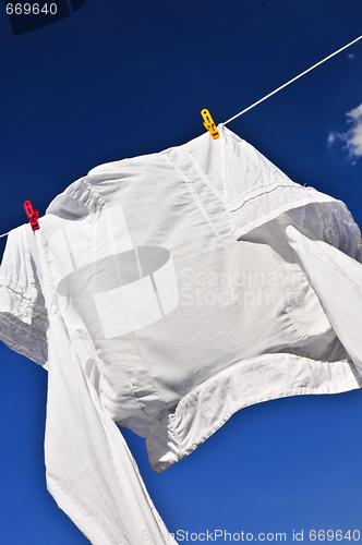 Image of White shirt on clothes line