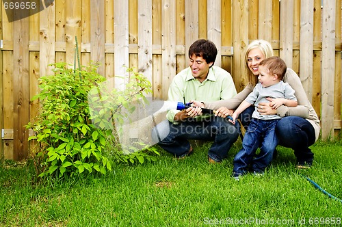 Image of Family watering plant