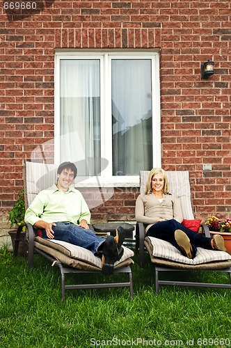 Image of Happy couple relaxing at home