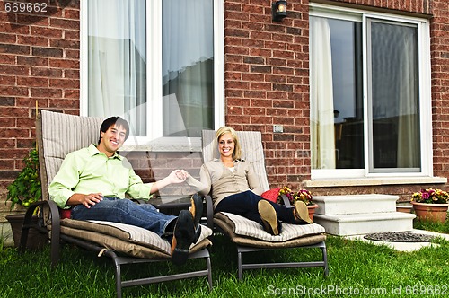 Image of Happy couple relaxing at home