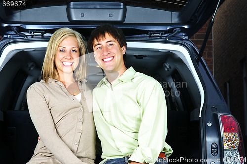 Image of Couple sitting in back of car