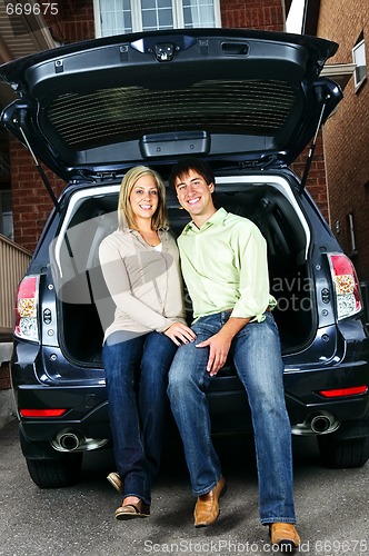 Image of Couple sitting in back of car