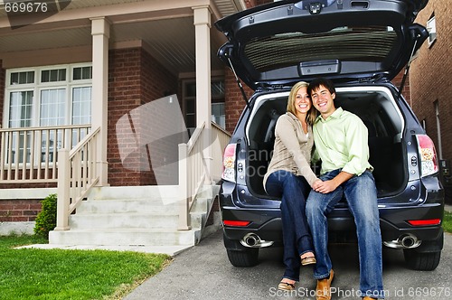 Image of Couple sitting in back of car