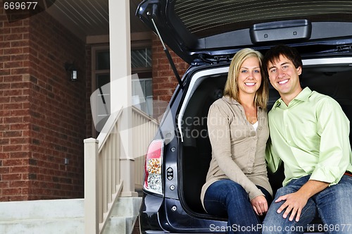 Image of Couple sitting in back of car