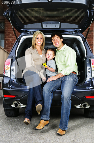 Image of Family sitting in back of car