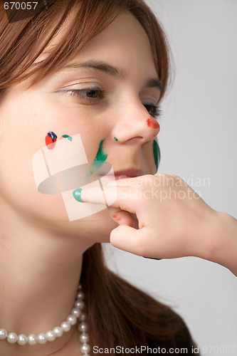 Image of beautiful girl with paint on face