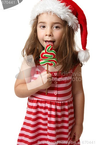 Image of Santa girl licking Christmas tree lollipop candy