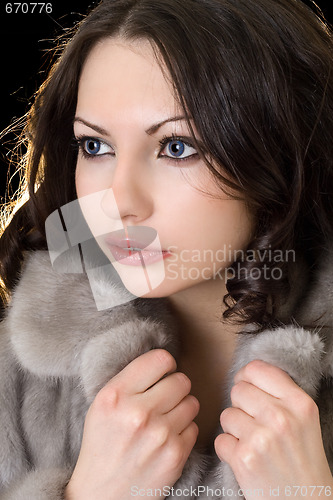 Image of Pretty young woman in a fur coat