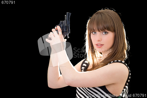 Image of Beautiful young woman with pistol. Isolated on black