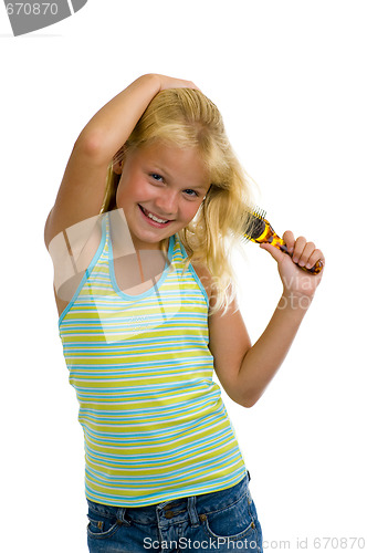 Image of cute blond girl brushing her hair