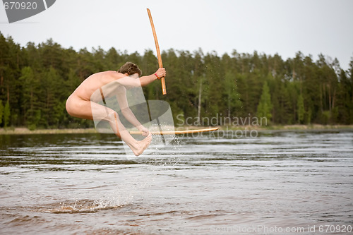 Image of nude man jumps in water