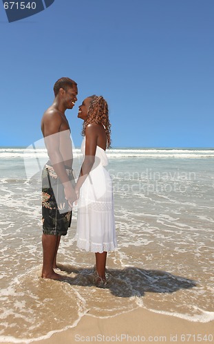 Image of Romantic African American Couple Holding Hands on the Beach