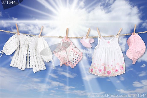Image of Baby Girl Clothing Hanging on a Clothesline Outdoors