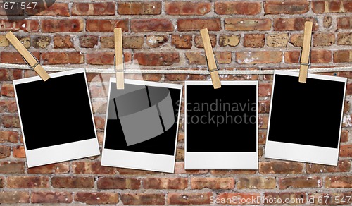 Image of Empty Film Blanks Hanging Against a Grungy Brick Wall