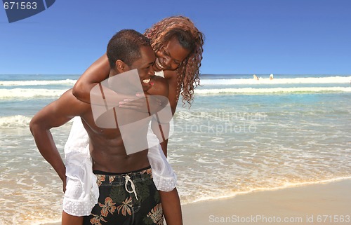 Image of Loving Couple Playing Along the Beach