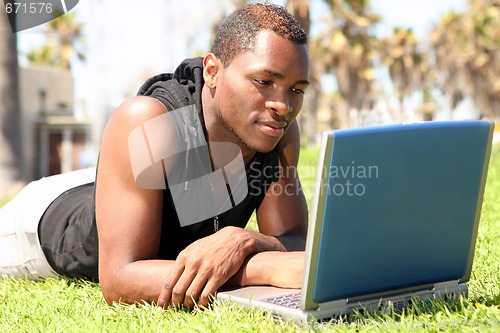 Image of Student of African Amercian Descent Wotking on a Laptop