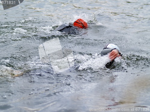 Image of two triathltes swimming