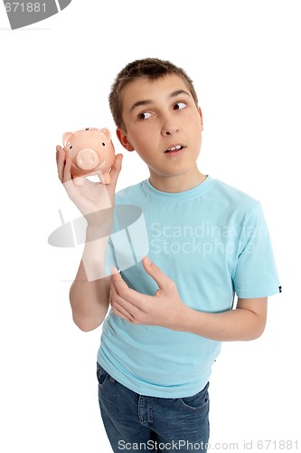 Image of Pre teen boy rattling a money box