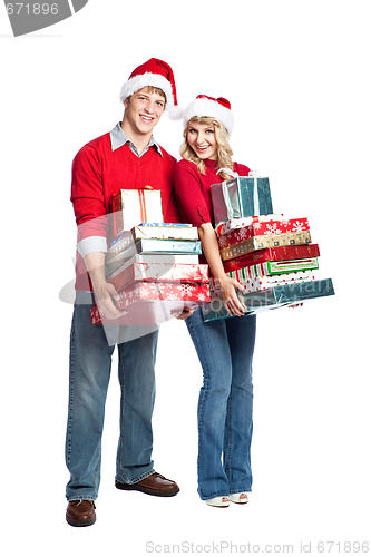 Image of Christmas shopping couple carrying gifts