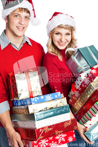 Image of Christmas shopping couple carrying gifts