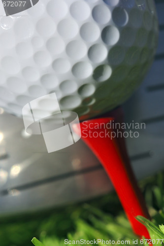 Image of Golf club and ball in grass