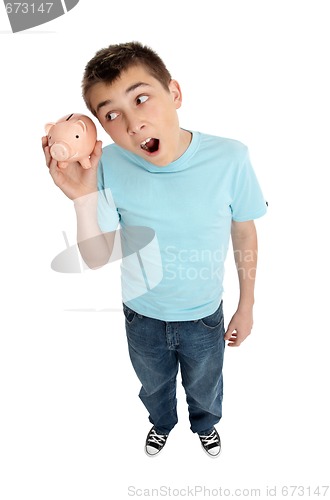 Image of Surprised boy shaking money box