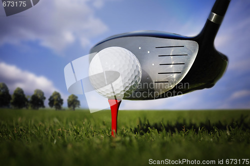 Image of Golf club and ball in grass