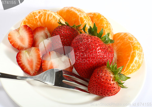 Image of Strawberries and tangerines with fork