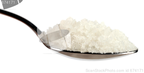 Image of Tablespoon of coarse sea salt against white